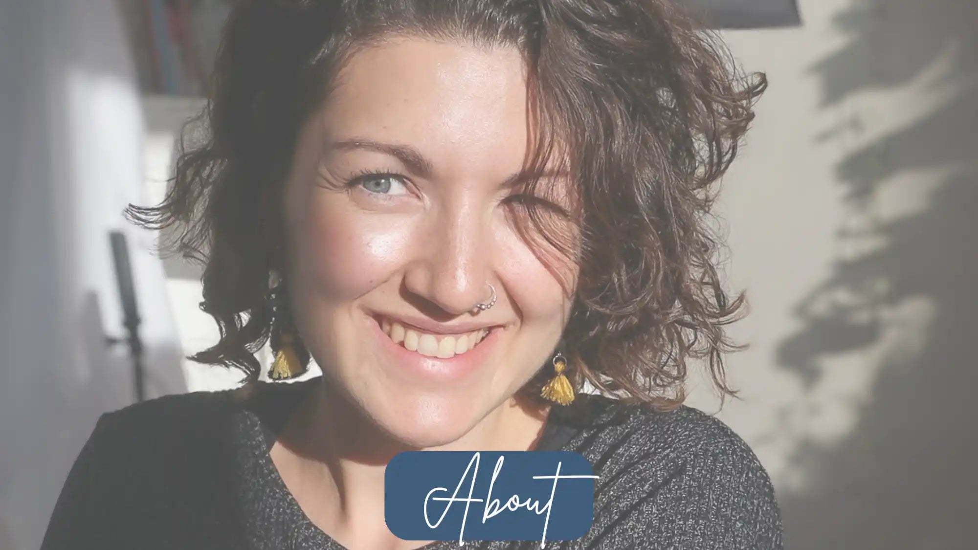 Smiling woman with curly hair.